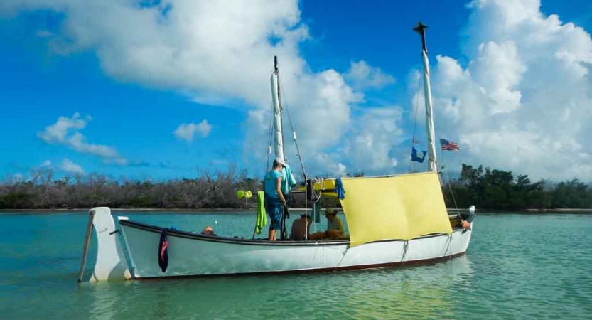 a sailboat floats in calm blue water on an outward bound expedition in florida